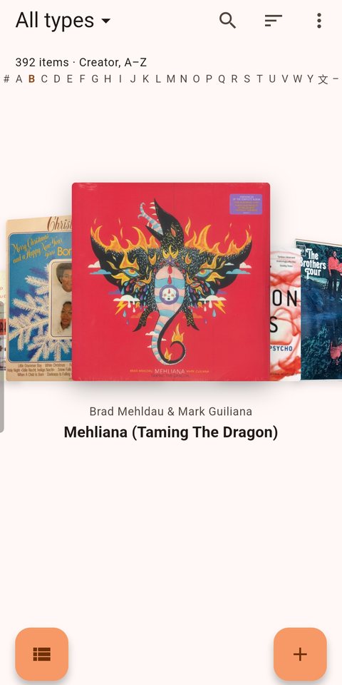 The Meibo home screen showing a carousel of album covers, with the centre cover enlarged and its artist and title beneath.